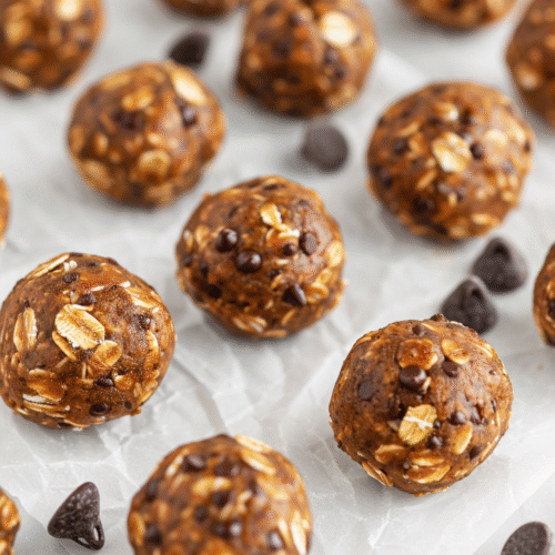 No-bake peanut butter oat energy balls on parchment